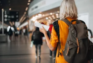 girl having flight ticket on his hand walking in the napa california airport